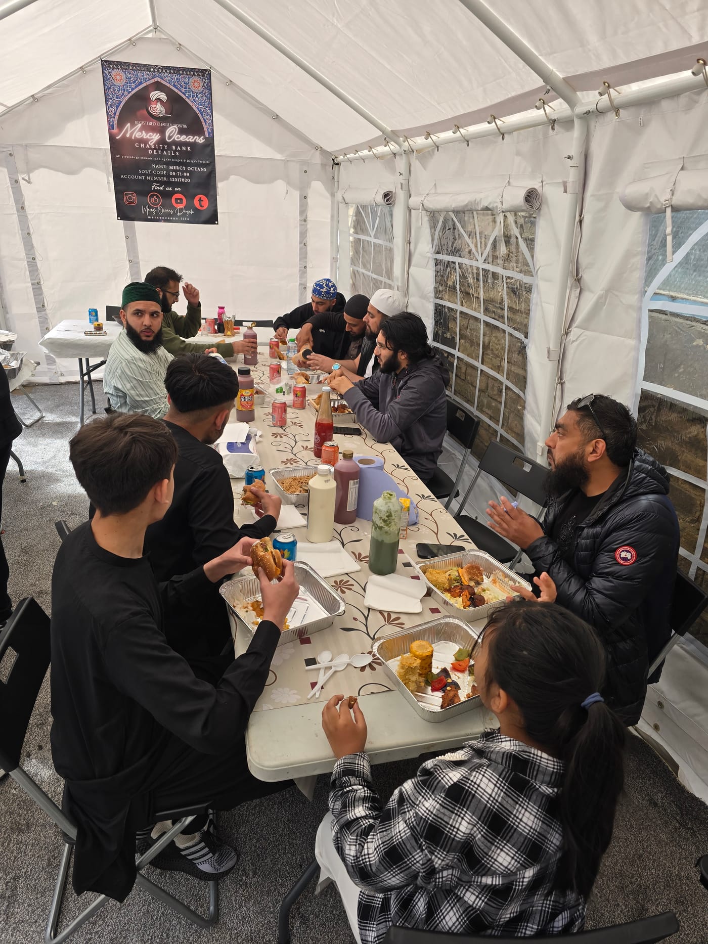 Guests sharing a meal together in the marquee after a gathering.